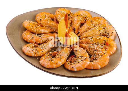 Fried shrimps on a plate with sesame and two slices of lemon Stock Photo