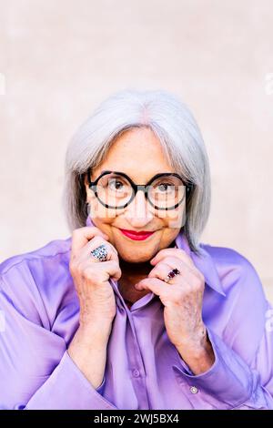 nice senior woman in glasses smiling looking at camera Stock Photo