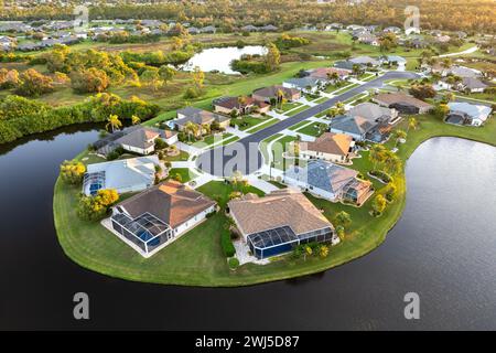 Low-density private homes at sunset. Rural street cul-de-sac dead end in residential suburbs with upscale suburban houses outside of Sarasota, Florida Stock Photo