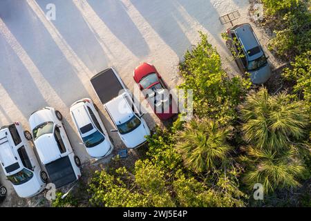 Parking lot at Blind Pass beach on Manasota Key in Englewood. Tourists cars in front of ocean beach with soft white sand in Florida. Popular vacation Stock Photo