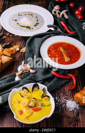 Three different vegetable cream soups on wooden Stock Photo