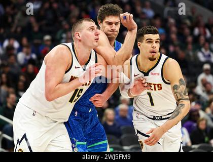 Milwaukee, USA. 12th Feb, 2024. Denver Nuggets center Nikola Jokic (L) and forward Michael Porter Jr. (R) battle for position with Milwaukee Bucks center Brook Lopez during the 2023-2024 NBA regular season game between Denver Nuggets and the Milwaukee Bucks at Fiserv Forum in Milwaukee, the United States, on Feb. 12, 2024. Credit: Joel Lerner/Xinhua/Alamy Live News Stock Photo