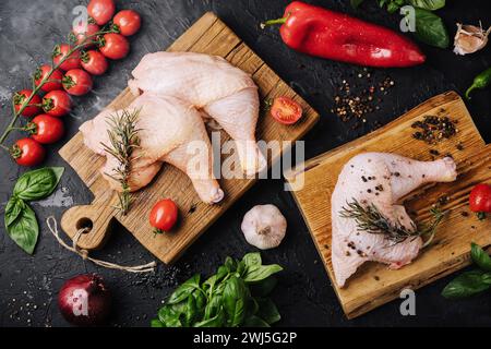 Fresh raw chicken thighs, legs on a cutting board with spices Stock Photo