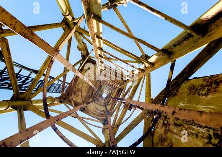 Old high metal tower building with stairs bottom view Stock Photo