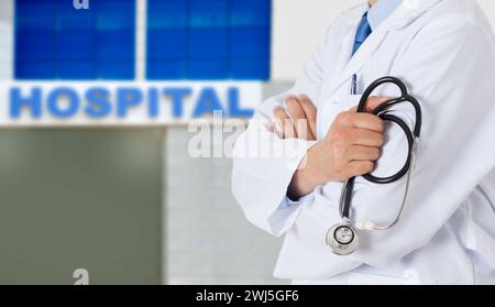 Cropped shot of a unrecognizable male doctor standing with his arms folded outside of a hospital during the day Stock Photo