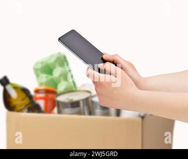 Cropped shot of a unrecognizable female hands using calculator apps with white background Stock Photo