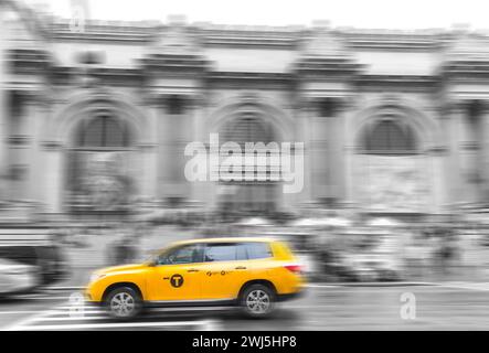 Yellow taxi Cab at The Metropolitan museum in New York City in black and white toning with motion blur effect Stock Photo