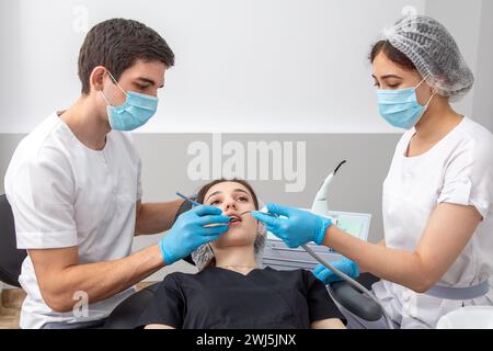 Group of students in dental clinic learn watching dental treatment with a microscope Stock Photo