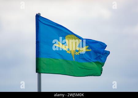 The flag of the Airborne Troops of Russia is flying in the wind against a cloudy sky. Stock Photo