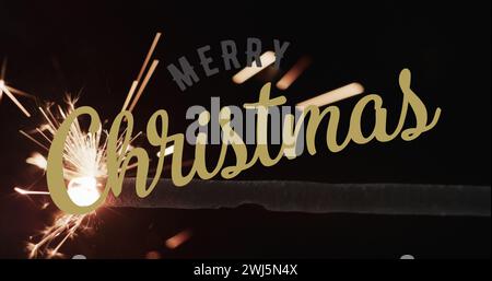 Image of merry christmas text over sparkler on black background Stock Photo