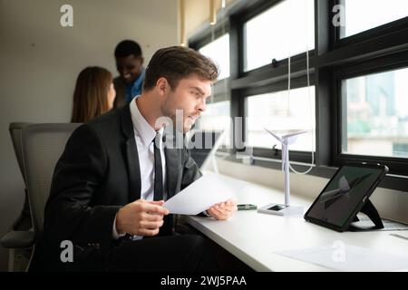 Young businessman and diverse group of business people working together in office, Brainstorming on how to use natural energy fr Stock Photo