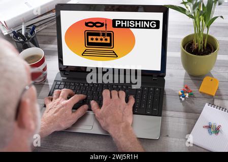 Phishing concept shown on a laptop used by a man Stock Photo