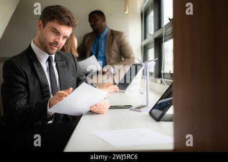 Young businessman and diverse group of business people working together in office, Brainstorming on how to use natural energy fr Stock Photo