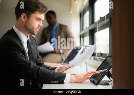 Young businessman and diverse group of business people working together in office, Brainstorming on how to use natural energy fr Stock Photo