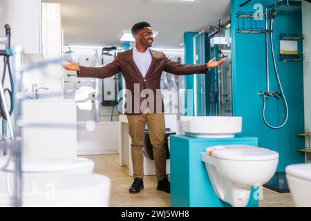 Portrait of salesperson in bathroom store. Happy man works in bath store. Sales occupation. Stock Photo