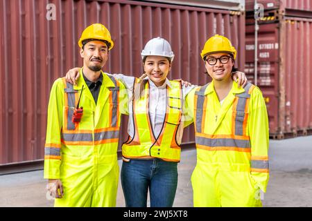 Female and two male workers donning yellow safety vests Stock Photo