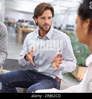 Businessman, communication or brainstorming with team in circle, idea or collaboration on website project. Web designer, discussion or diversity in Stock Photo