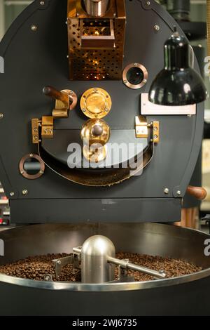 Close up of coffee roasting machine with coffee beans in small coffee ...
