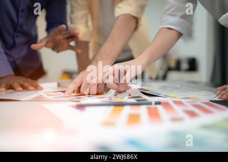 Multiethnic team of architects and designers are meeting to brainstorm design an application smartphone on a bright modern offic Stock Photo