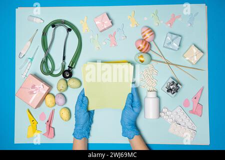 Medical Easter. Hands in gloves holding blank sheet of paper, space for text, top view. Stock Photo
