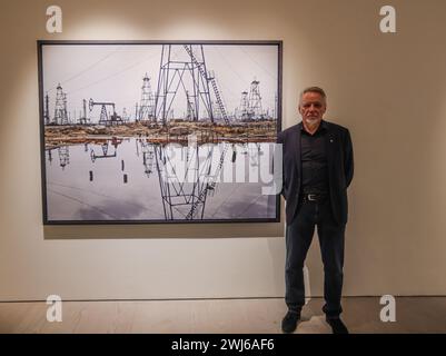 London, UK. 13th Feb, 2024. Edward Burtynsky (pictured) next to SOCAR Oil fields Baku Azerbaijan, 2006.This exhibition marks the largest exhibition ever mounted in the 40  year career of world-renowned photographic artist, Edward Burtynsky, who has dedicated his practice to bearing witness to the impact of human industry on the planet.Paul Quezada-Neiman/Alamy Live News Credit: Paul Quezada-Neiman/Alamy Live News Stock Photo