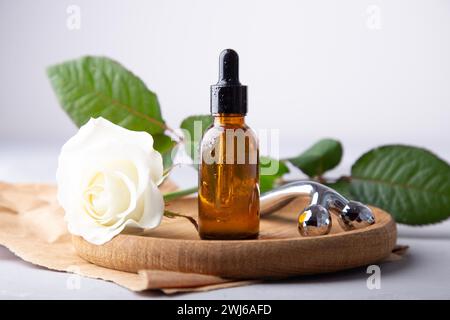 Self care composition with facial serum, facial roller. Wellness and beauty concept with natural elements and skincare products. Stock Photo