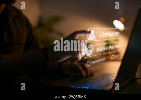 Computer Security Concept With Online Log In Credential Projected Onto Screen Of Person Using Laptop Stock Photo