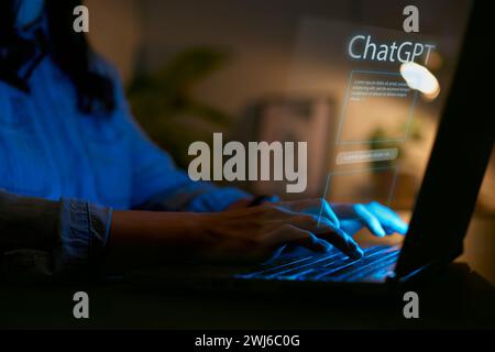 Computer AI Concept With Overlay Of Interface For ChatGPT Projected Onto Screen Of Woman Using Laptop Stock Photo