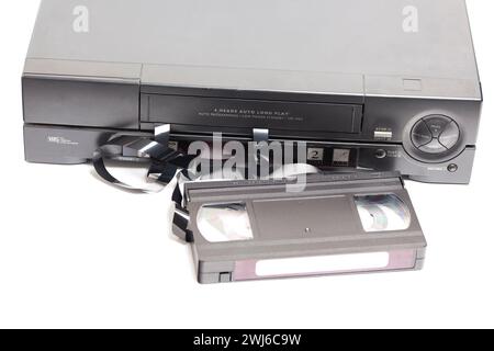 Retro video cassette recorder with VHS cassette with unwound tape isolated on white background Stock Photo