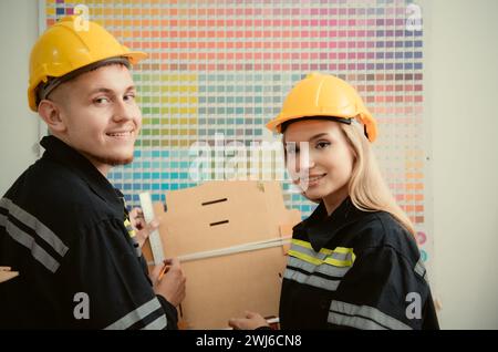 Warehouse workers in uniform and hardhats working in a paper factory Stock Photo
