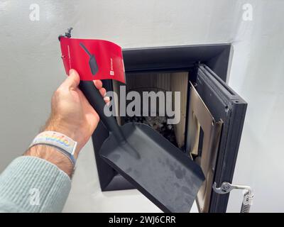 A man confidently opens a fire door using a Dixineuf tool for cleaning Stock Photo