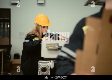 Warehouse workers in uniform and hardhats working in a paper factory Stock Photo