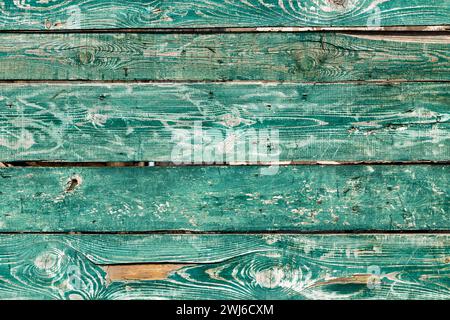 Wooden texture of an old fence made of painted green rustic boards Stock Photo