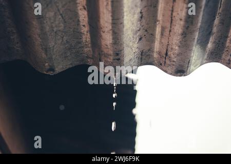 raindrops on the roof of the house against a blurred background Stock Photo