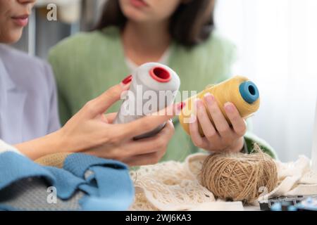 Two female fashion designers are working on a new collection of clothes. Stock Photo