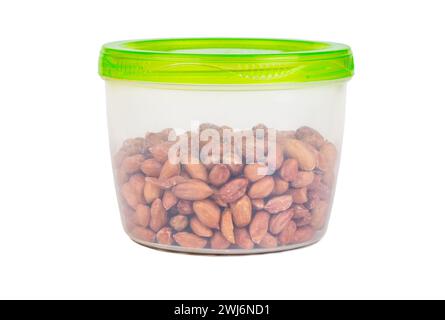 Raw peanuts in a plastic container isolated on a white background Stock Photo
