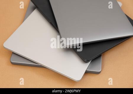 Different modern laptops on brown background, closeup Stock Photo