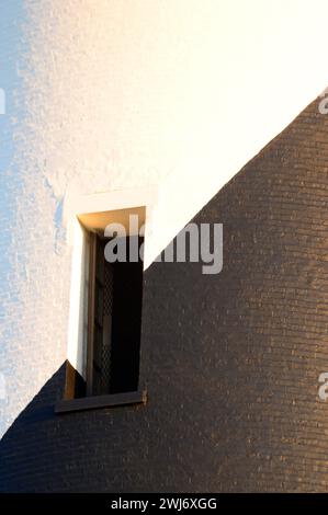 A detail of a window cut by the swirling black and white stripes on the Cape Hatteras Lighthouse on the Outer Banks of North Carolina Stock Photo