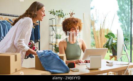 Two Women Friends Running Online Fashion Business From Home Together Stock Photo