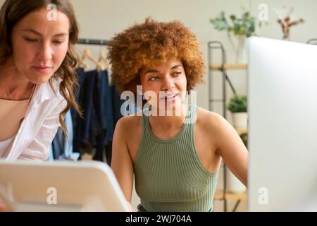 Two Women Friends Running Online Fashion Business From Home Together Stock Photo