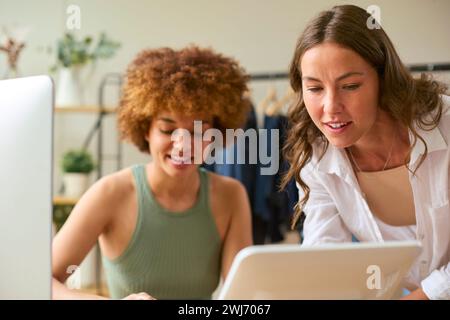 Two Women Friends Running Online Fashion Business From Home Together Stock Photo