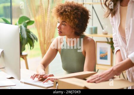 Two Women Friends Running Online Fashion Business From Home Together Stock Photo