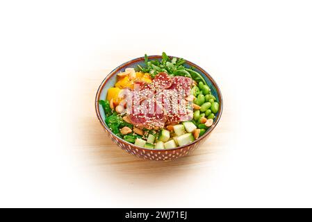 Poke bowl with sliced tuna and vegetables isolated on white Stock Photo