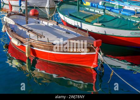 Rows of colourful rowing boats called 'pointus'. Used as fishing boats and now used by families too. Moored here at picturesque Port Lympia in Nice. Stock Photo