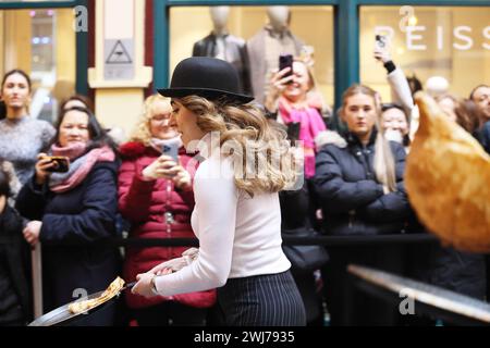 London, UK 13th February 2024. Famous 18th century pub The Lamb Tavern hosted it's legendary and 15th pancake race in Victorian covered Leadenhall Market for Shrove Tuesday.  Teams of 4 compete for glory and a golden frying pan during a 20m flipping relay. Credit : Monica Wells/Alamy Live News Stock Photo