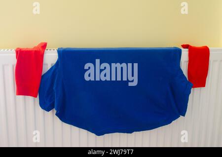 Wet Laundry Washing Clothing Drying On A Central Heating Radiator Stock Photo