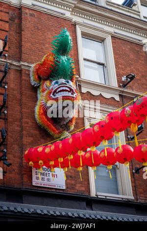 London. UK- 02.11.2024. The figure of a mythical lion hanging on the wall of a building in China Town as part of the Lunar New Year celebration. Stock Photo