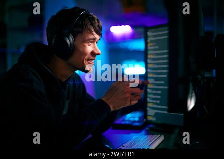 Low Key Lighting Shot Of Male Gamer In Front Of Computer Screens With ...
