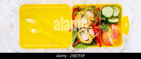 School lunch box with sausage roll in omelette with lavash. Lunchbox. Keto lunch. Top view, flat lay Stock Photo