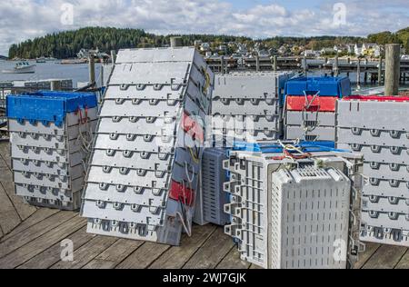 Lobster Holding Boxes:  Plastic crates for storing and shipping fresh lobsters sit in stacks on a New England dock. Stock Photo